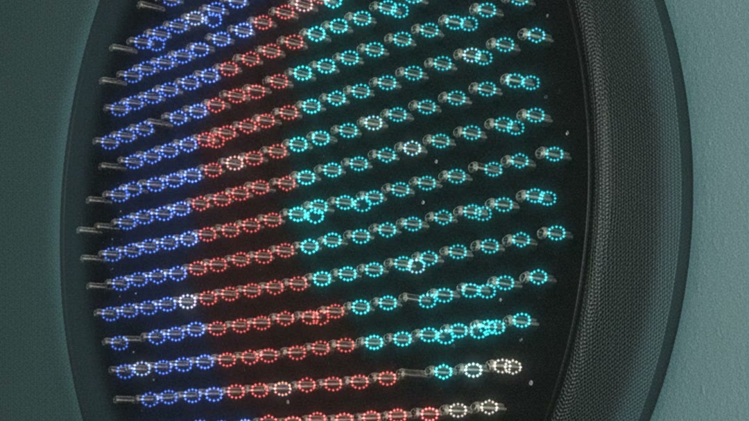 Close on the array with music playing: bands of blue, red and cyan light in the LED rings at the base of each spring
